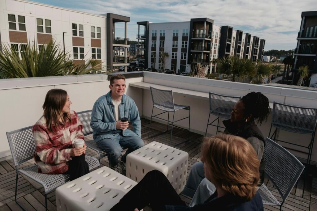 Apartment residents socializing together at a rooftop lounge event