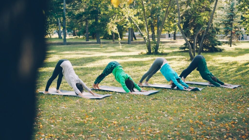 Apartment residents taking part in an outdoor yoga class on the community lawn